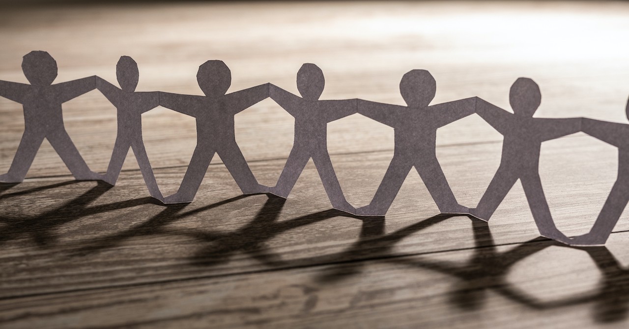 paper figure chain cut outs linked arm to arm on table, what does it mean to be equally yoked