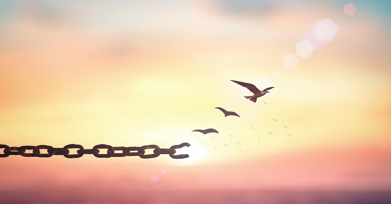 broken chains with birds flying off in sunset background to freedom, generational curses