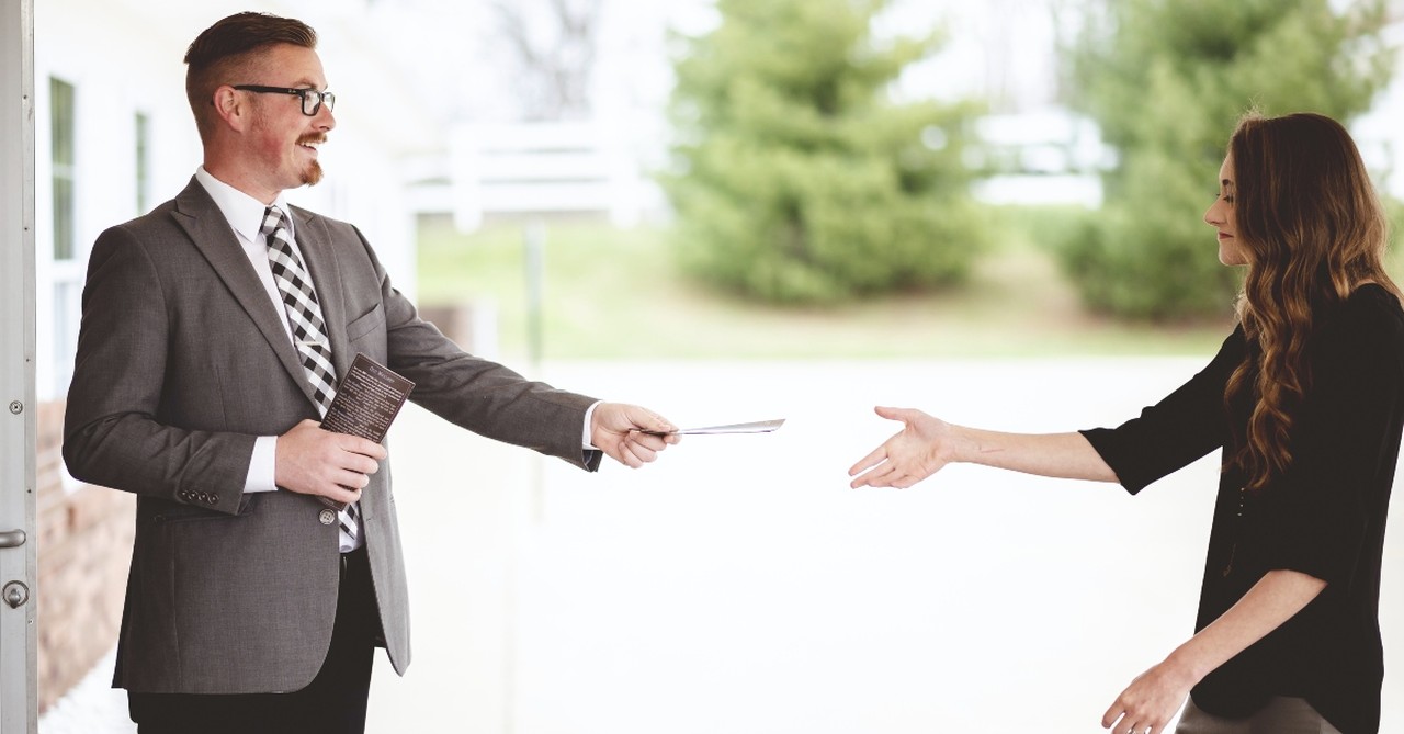 Man welcoming a woman to church