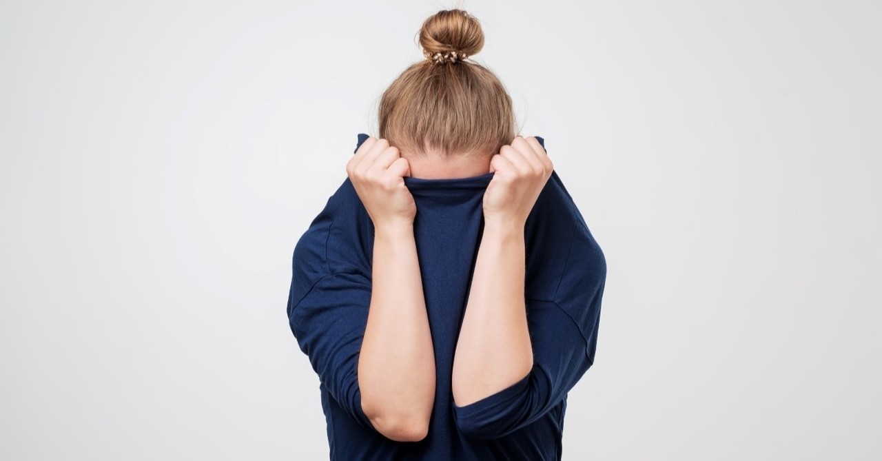 woman hiding face in shirt, introvert christians