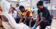 Ravens Players Model Jesus’ Servant Leadership by Washing Schoolchildren’s Feet