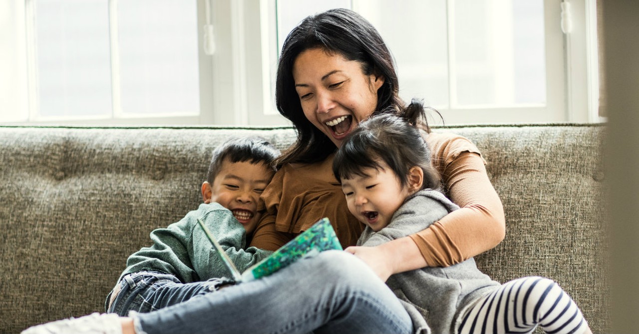 mom reading to her kids on the couch