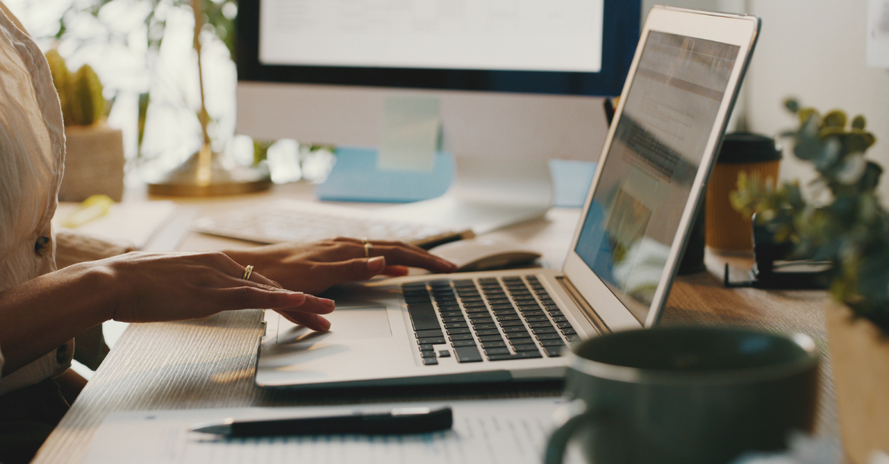 open laptop with hands ready to type